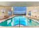 Indoor pool area with floor-to-ceiling windows offering natural light and views at 1709 S Ocean Blvd. S # 205, North Myrtle Beach, SC 29582