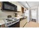 Functional kitchen equipped with appliances, ample counter space, and a tile floor at 1709 S Ocean Blvd. S # 205, North Myrtle Beach, SC 29582