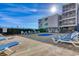 Outdoor pool and sundeck with comfortable lounge chairs on a sunny day at 1709 S Ocean Blvd. S # 205, North Myrtle Beach, SC 29582