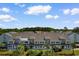 Exterior view of Unit #17-S townhome with blue and gray siding, and palm trees at 1890 Colony Dr. # 17S, Myrtle Beach, SC 29575