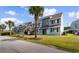A row of two-story townhomes in a neutral paint color, lush landscaping, and palm trees at 1890 Colony Dr. # 17S, Myrtle Beach, SC 29575