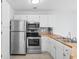 Bright kitchen featuring white cabinets, butcher block counters, and stainless steel appliances at 1890 Colony Dr. # 17S, Myrtle Beach, SC 29575
