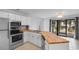 White kitchen cabinets and butcher block countertops, stainless steel appliances with view of patio at 1890 Colony Dr. # 17S, Myrtle Beach, SC 29575