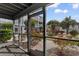Relaxing screened patio with lush landscaping featuring red roses and palm trees at 1890 Colony Dr. # 17S, Myrtle Beach, SC 29575