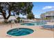 Community pool featuring a hot tub, lounge chairs, tables, and chairs at 1890 Colony Dr. # 17S, Myrtle Beach, SC 29575