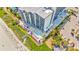 Aerial view of condo building with pools, beach access, and lush landscaping at 2001 S Ocean Blvd. # 210, Myrtle Beach, SC 29577
