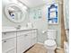 Well-lit bathroom featuring a sink with vanity, a toilet, and coordinated decor at 2001 S Ocean Blvd. # 210, Myrtle Beach, SC 29577