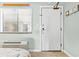 Cozy bedroom featuring a beach theme, window with blinds, and a convenient exit door at 2001 S Ocean Blvd. # 210, Myrtle Beach, SC 29577