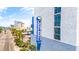Exterior view of a Blue Water Resort building with palm trees and street view at 2001 S Ocean Blvd. # 210, Myrtle Beach, SC 29577
