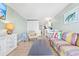 Open-concept living room with a colorful sofa and access to the kitchen at 2001 S Ocean Blvd. # 210, Myrtle Beach, SC 29577