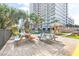 Outdoor picnic area with colorful picnic tables and a tiki hut for shade at 2001 S Ocean Blvd. # 210, Myrtle Beach, SC 29577