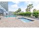 Relaxing pool and hot tub area surrounded by brick pavers, lush landscaping, and palm trees at 2001 S Ocean Blvd. # 210, Myrtle Beach, SC 29577