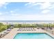 A sparkling pool with lounge chairs overlooks the beautiful beach and ocean at 2001 S Ocean Blvd. # 210, Myrtle Beach, SC 29577