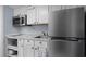 Compact kitchen features white cabinets, stainless steel appliances, and marble countertop at 208 74Th Ave. N # 2517, Myrtle Beach, SC 29572