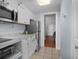Well-equipped kitchen features white cabinets, stainless steel appliances, and access to the bedroom at 208 74Th Ave. N # 2517, Myrtle Beach, SC 29572