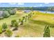 Expansive property featuring a modern farmhouse, private lake, and a charming red barn amid rolling green fields at 2300 Tansy Rd., Loris, SC 29569