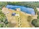 Breathtaking aerial view of an estate featuring a large pond, with a home, pastures and wooded areas at 2300 Tansy Rd., Loris, SC 29569