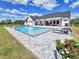 Beautiful backyard showcasing a rectangular pool, patio, lounge chairs and a well-manicured lawn at 2300 Tansy Rd., Loris, SC 29569