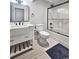 Modern bathroom featuring a white vanity, toilet, and a tiled shower with glass doors at 2300 Tansy Rd., Loris, SC 29569