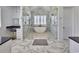 Bright bathroom boasts marble walls, soaking tub under window, and glass shower doors at 2300 Tansy Rd., Loris, SC 29569