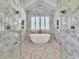 Bright bathroom features marble walls, soaking tub, tiled floor, and glass enclosed shower at 2300 Tansy Rd., Loris, SC 29569