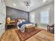 Charming bedroom with a wooden headboard, hardwood floors, accent wall and a decorative area rug at 2300 Tansy Rd., Loris, SC 29569
