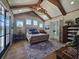 Bright bedroom with vaulted ceiling, wood beams, french doors, and a plush bed at 2300 Tansy Rd., Loris, SC 29569