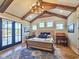 Bright bedroom with vaulted ceiling, wood beams, french doors, and a plush bed at 2300 Tansy Rd., Loris, SC 29569