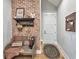 Charming entryway with brick accent wall, farmhouse bench, and wood floors at 2300 Tansy Rd., Loris, SC 29569