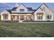Elegant white farmhouse with black framed windows, welcoming front porch and lush green lawn at 2300 Tansy Rd., Loris, SC 29569