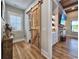 Stylish hallway with sliding barn door, wood floors, and built-in cabinets at 2300 Tansy Rd., Loris, SC 29569