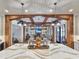 Open-concept living room with wood beam archway, modern decor, and built-in shelving around fireplace at 2300 Tansy Rd., Loris, SC 29569