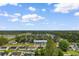 An aerial shot provides a view of the neighborhood and surrounding tree coverage at 2446 Farmwood Circle, Conway, SC 29527
