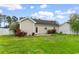 Exterior view of home showcasing the well-kept backyard, garden, and patio area at 2446 Farmwood Circle, Conway, SC 29527