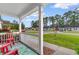 Charming front porch with red Adirondack chairs overlooking the landscaped front yard at 2446 Farmwood Circle, Conway, SC 29527