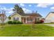 Inviting single-story home featuring a well-kept lawn and charming front garden at 2446 Farmwood Circle, Conway, SC 29527