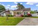 Charming single-story home with a cozy front porch and well-maintained landscaping at 2446 Farmwood Circle, Conway, SC 29527