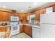 Bright kitchen featuring wooden cabinets, white appliances and stainless steel sink at 2446 Farmwood Circle, Conway, SC 29527