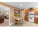 Bright kitchen and dining area showcasing wooden cabinetry and tile flooring at 2446 Farmwood Circle, Conway, SC 29527