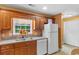 Bright kitchen featuring wooden cabinets, white appliances and stainless steel sink at 2446 Farmwood Circle, Conway, SC 29527