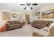 Inviting living room with neutral walls, ceiling fan, and comfortable seating arrangement at 2446 Farmwood Circle, Conway, SC 29527