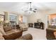 A well-lit living room with neutral walls, vaulted ceiling with ceiling fan, and comfortable furnishings at 2446 Farmwood Circle, Conway, SC 29527