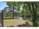 Scenic view of the backyard with a lake and mature trees providing shade and privacy at 2703 Canvasback Trail, Myrtle Beach, SC 29588