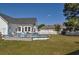 Spacious backyard featuring an above-ground pool, lush lawn, and a white picket fence at 2703 Canvasback Trail, Myrtle Beach, SC 29588