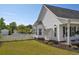 Landscaped backyard features a white picket fence, an above-ground pool, and mature landscaping at 2703 Canvasback Trail, Myrtle Beach, SC 29588