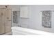 Bright bathroom featuring a glass-enclosed shower, a white cabinet and patterned towels at 2703 Canvasback Trail, Myrtle Beach, SC 29588
