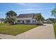 Charming single-story home with a welcoming front porch, long driveway, and mature landscaping at 2703 Canvasback Trail, Myrtle Beach, SC 29588