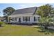 Inviting front porch with rocking chairs and decorative plants, creating a warm welcome at 2703 Canvasback Trail, Myrtle Beach, SC 29588