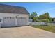 White two-car garage with a well-kept driveway, complemented by a neat white picket fence at 2703 Canvasback Trail, Myrtle Beach, SC 29588