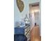 Hallway featuring a decorative table and driftwood art piece, leading to a bright, wood-floored passage at 2703 Canvasback Trail, Myrtle Beach, SC 29588